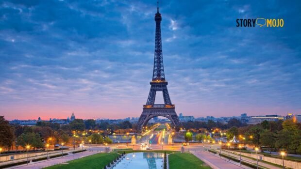 a large tower with a body of water and a road with Eiffel Tower in the background