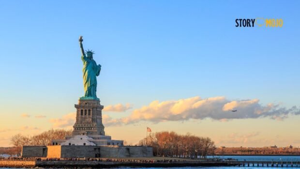 a statue of liberty with a plane flying over it with Statue of Liberty in the background