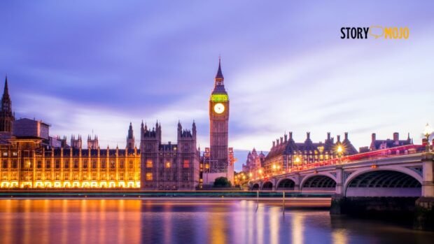 a large building with a clock tower and Big Ben over water